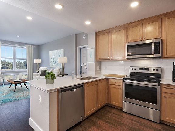 Renovated Package II Kitchen, living, and dining areas with hard surface flooring