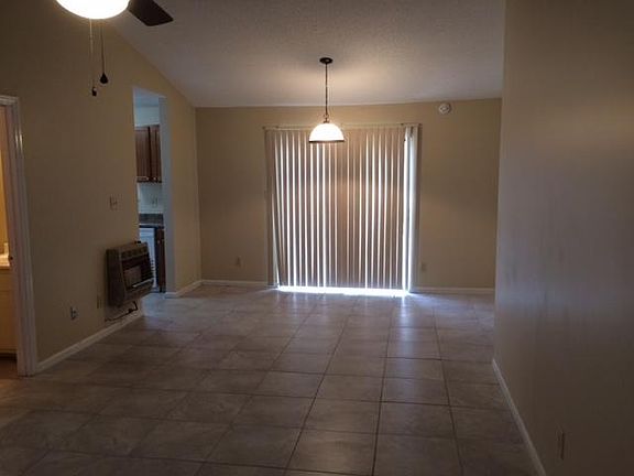 Open living room/dining room w/ vaulted ceiling