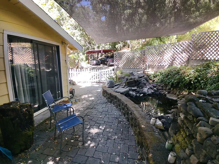 Yard between dining room and pond with waterfall.