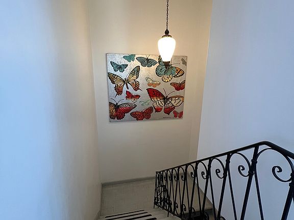 From top of interior stairway. Front door is at bottom of stairway.