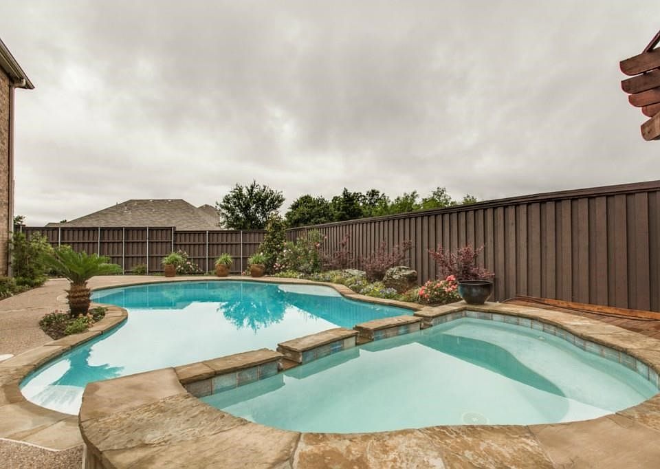 There is a Cedar Pergola behind this spa with a deck.