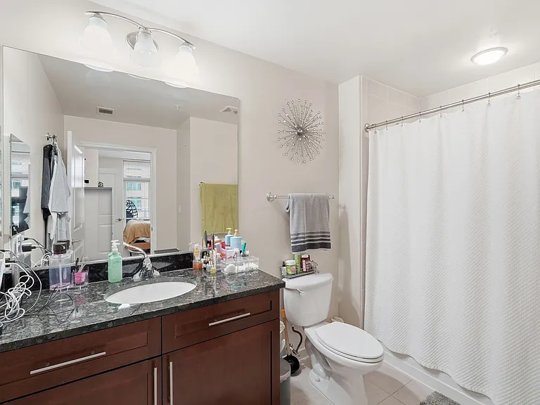 Primary bathroom with granite vanity and full bathtub/shower combination