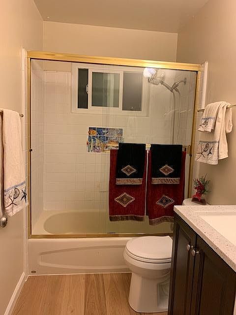 Bath with new floor, new vanity, mirror and new toilet; fresh paint; new window