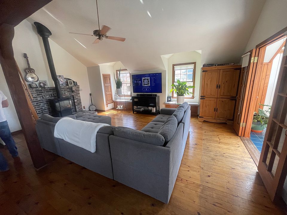 Living room with terrace, Franklin stove with sun room on the right.