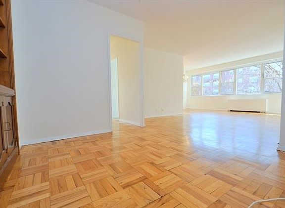 Bright and sunny foyer, living room and dining area have refinished parquet floors and overlooks tree lined Garth Road.  There is a door that leads to a private screened in balcony with Southern exposures.  The living roo is 20'-1" x 12'-0" the dining are