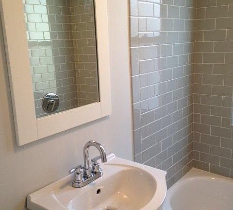 Bathroom with custom grey subway tile & modern chrome finishes
