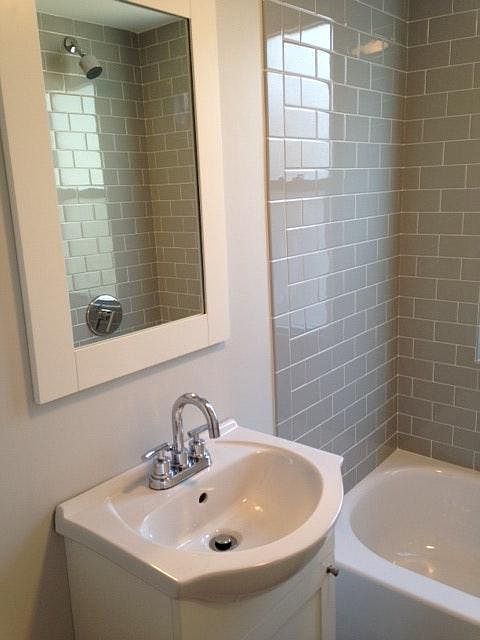 Bathroom with custom grey subway tile & modern chrome finishes