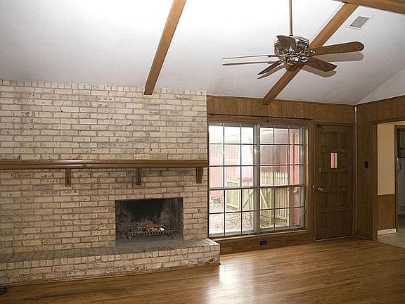 The living rooms has vaulted ceilings and ceiling fans with great wood floors with lots of natural light that lead out to the back yard!