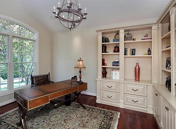 Study/den with vaulted ceiling and custom painted and glazed maple cabinetry & bookshelves.