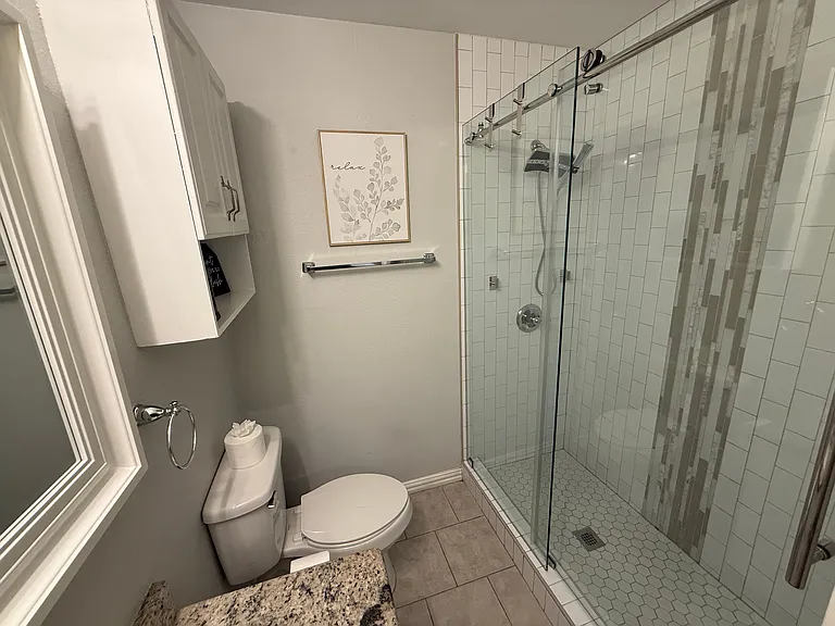Full Bathroom 1 - walk-in shower and bathroom essentials.