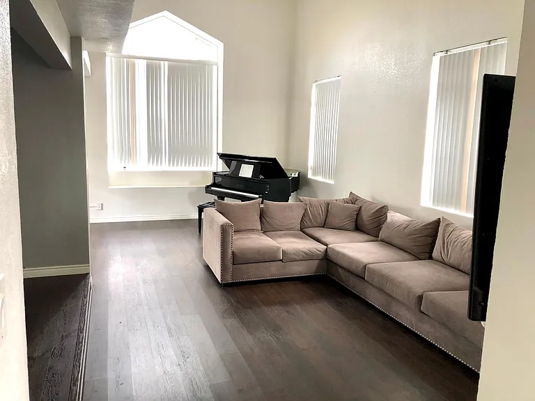 large living room with vaulted ceilings. Formal dining room on the left