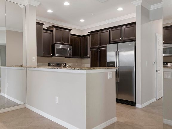 Stunning mocha cabinets add to the charming style of the kitchen