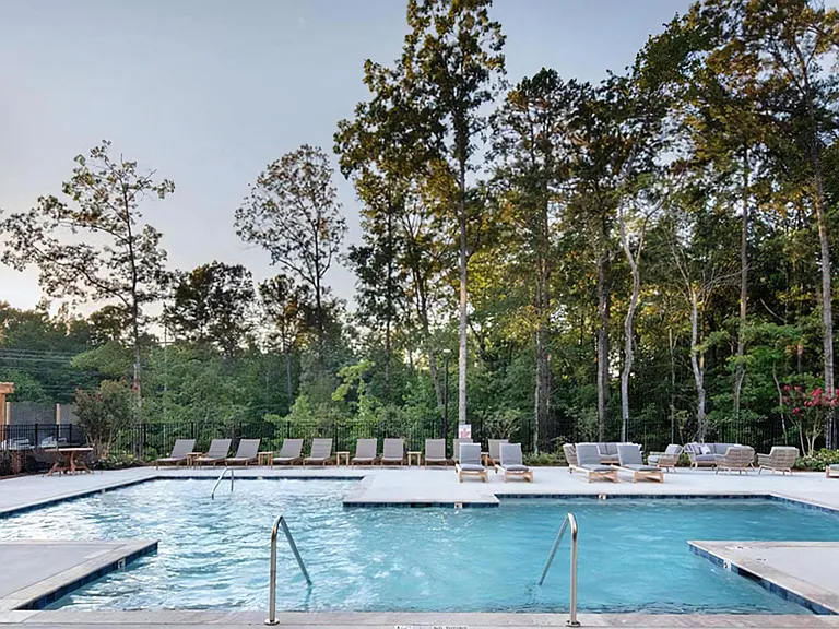 Peaceful Outdoor Pool Area with Lounge Chairs and Natural Views