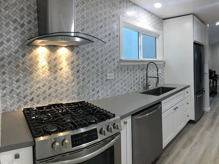 High-end appliances: Stainless Steel finishes with custom tile. GAS stove/oven, dishwasher, flush refrigerator w/ice maker and filtered water, garbage disposal