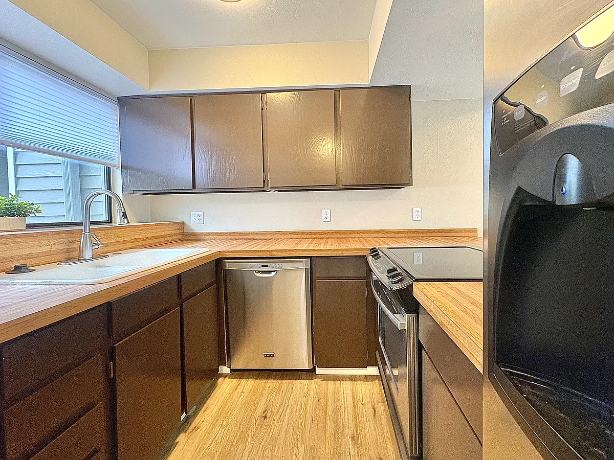 Light bright kitchen. 
Amana stainless steel fridge with ice and water in the door. Stainless steel slide in electric cooktop with oven. Stainless steel Maytag dishwasher. - 67 S Nome St