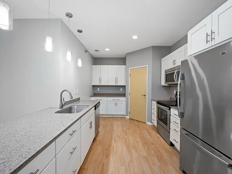 Contemporary kitchen with sleek stainless steel appliances, elegant countertops, and modern lighting fixtures. Contemporary kitchen with sleek stainless steel appliances, elegant countertops, and modern lighting fixtures.