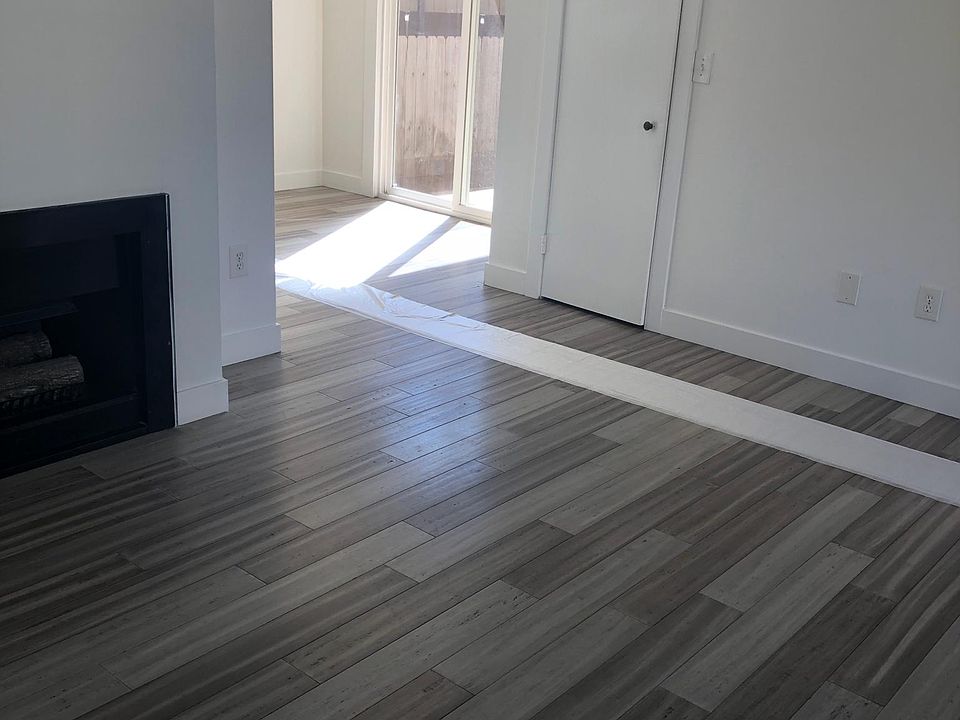Living Room with fire place leading to the dining room and kitchen.