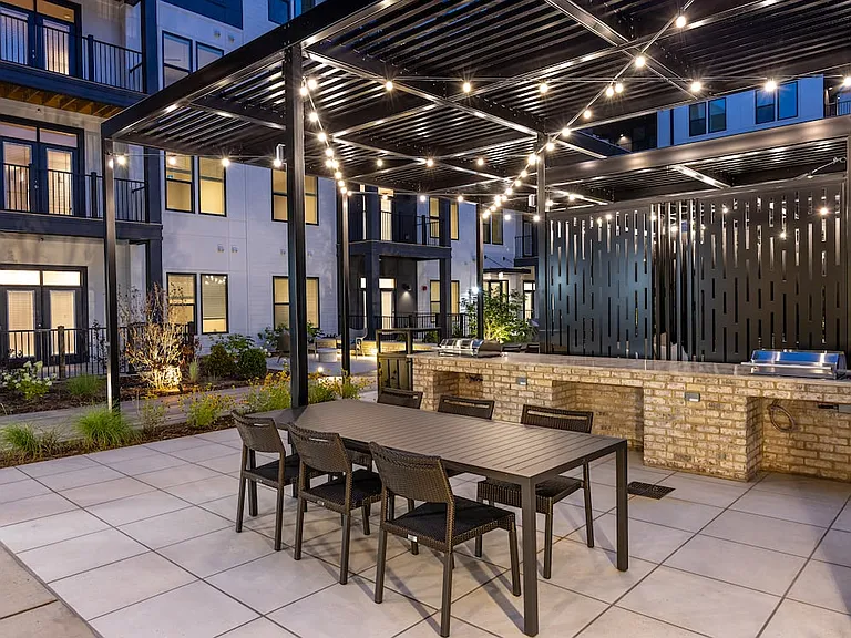 Pool courtyard with barbecue grill stations and dining tables