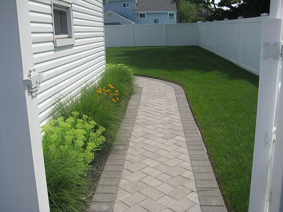 paver walk to newly fenced backyard