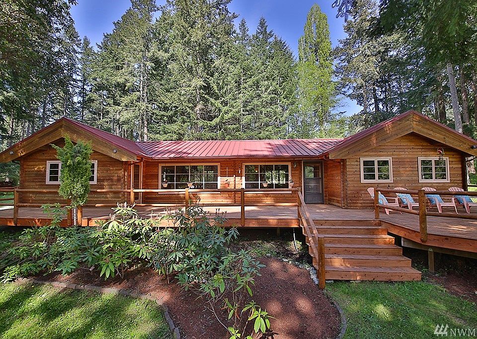 Here is the front exterior.  The rich wood tones in combination with the red metal roof provide curb appeal, character and charm!