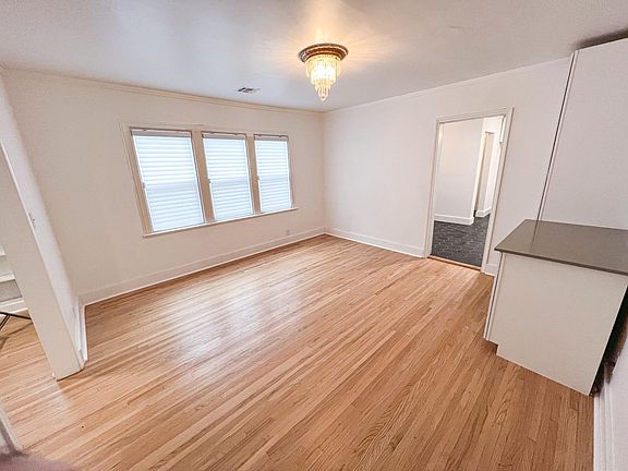 Dining room with original hardwoods and chandelier! Features a wine cooler and drybar.