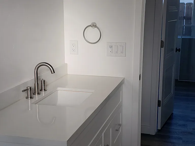 Hall bathroom with new hardware. A tankless water heater with "circulator" provides endless hot water.
