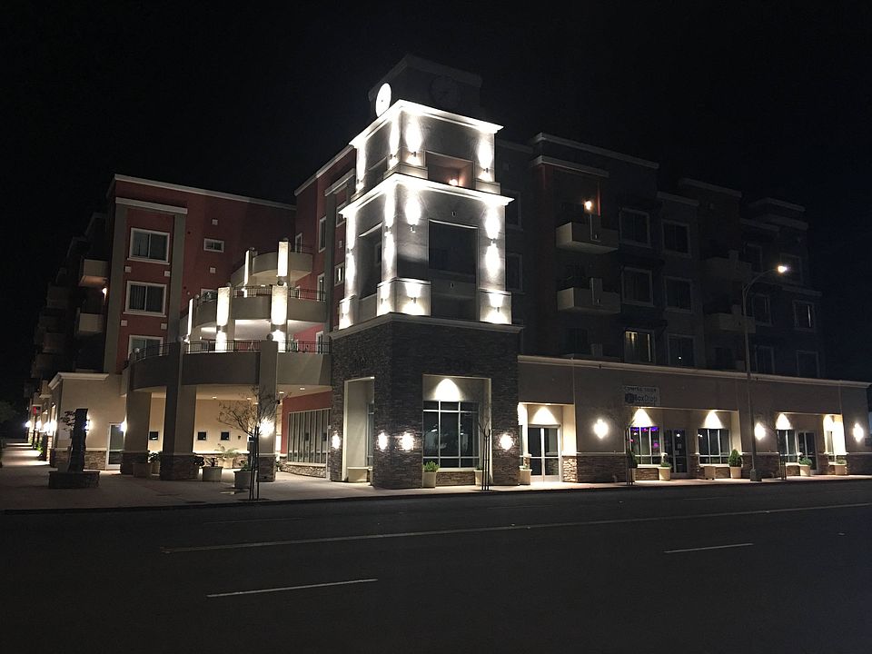 Night time stree view of City Plaza Apartments in Escondido, California.