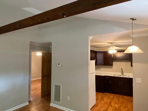 Spacious living, open floor plan with entry to kitchen and second bedroom.