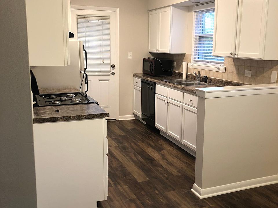 Kitchen and eating area. The kitchen has a new stove and new fridge (not pictured). All the cabinets have been refinished with new hardware.