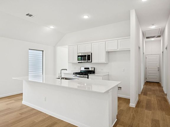 Kitchen in the Spruce home plan by Trophy Signature Homes - REPRESENTATIVE PHOTO