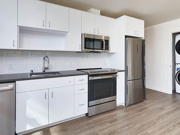 Kitchen with Stainless Steel Appliances and In-home Washer and Dryer