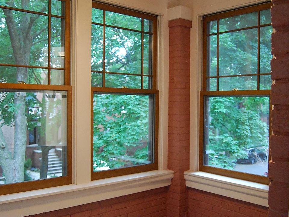 Restored Sunporch with new wood windows, light and ceiling fan.