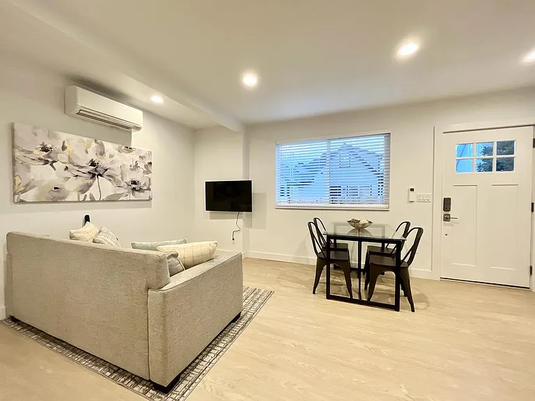 Modern elegance unfolds in our open-concept living, dining, and kitchen area.