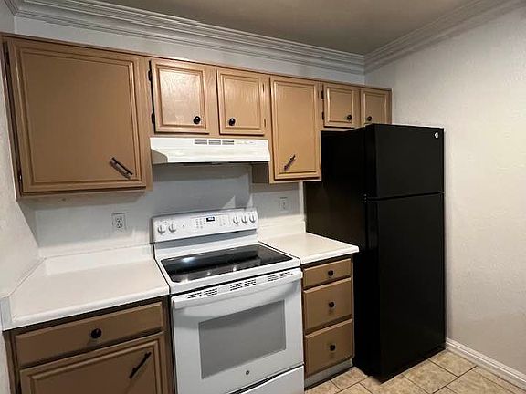 Kitchen with newly renovated cabinets. Stove, oven, full sized fridge with freezer.