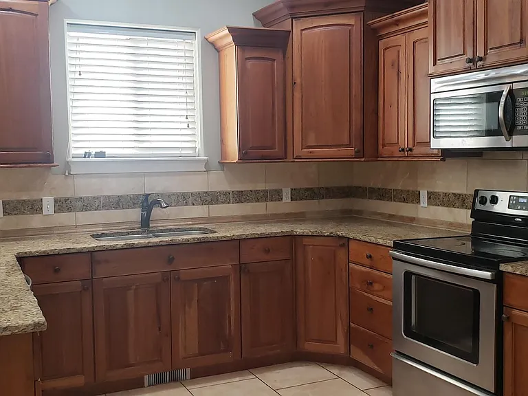 Granite countertops provide abundant room for food prep and family gatherings.