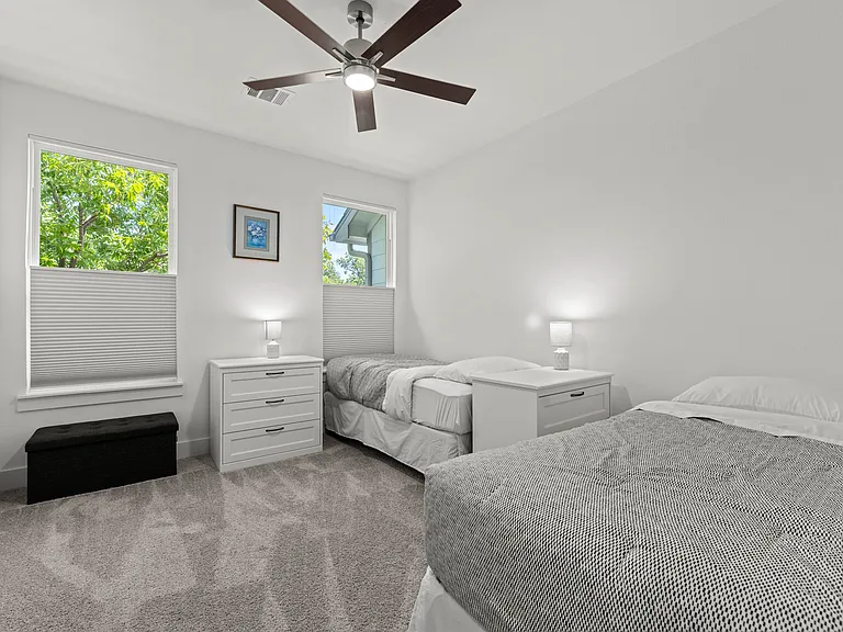 The third bedroom offers two twin beds that can be pushed together to form a king bed. It has two dressers and a storage bench.