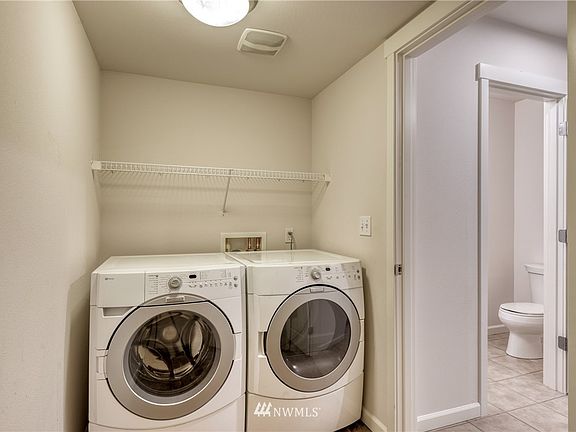 View from the laundry room of your full-sized washer/dryer set that stay and the first floor powder room next to the laundry room.