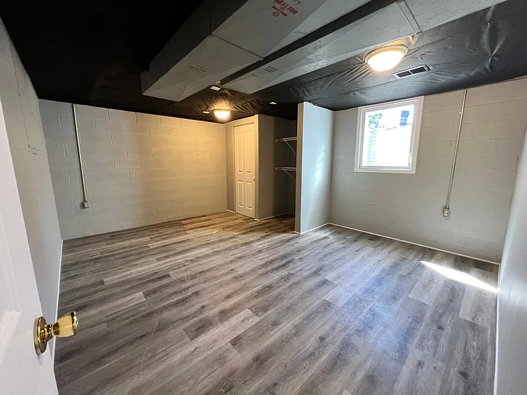 newly completed 4th bedroom in lower level, egress window
