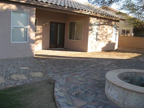 walled backyard with firepit
