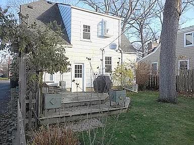 Back of the house with deck and grill.