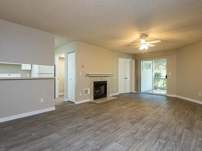 Two Bedroom w/ Den | Living Room with Fireplace and Patio