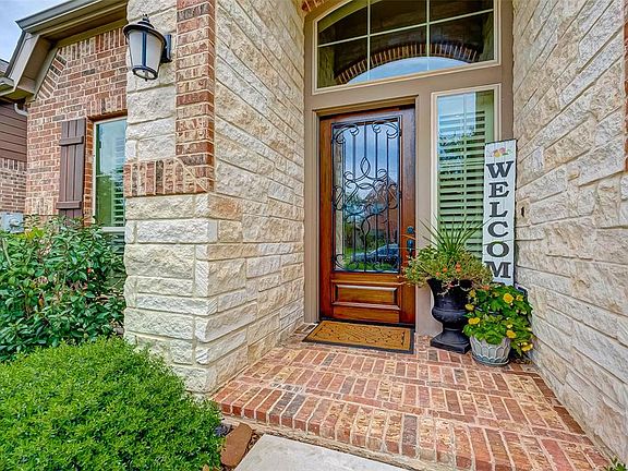 Beautiful Wood and wrought iron front door is just the beginning of WOW....