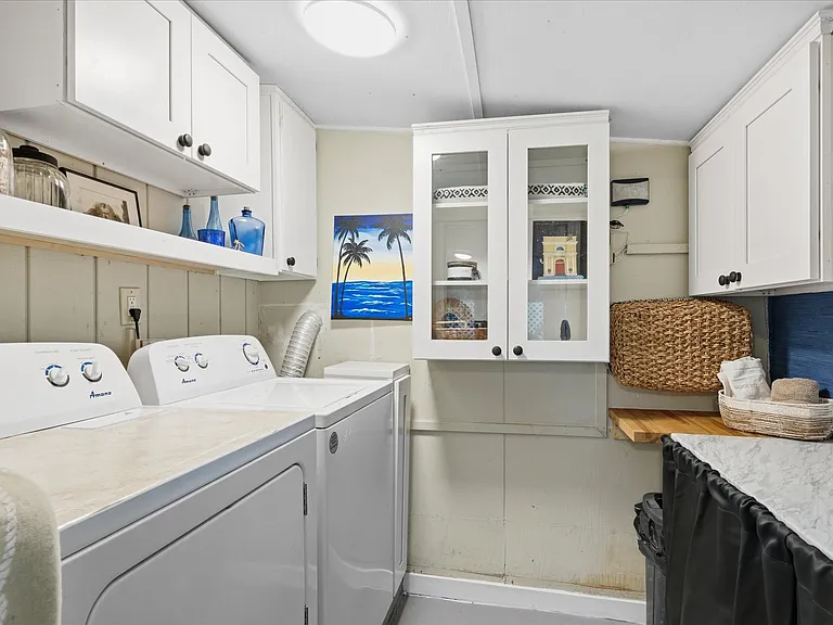 Laundry area with counter space and storage.
