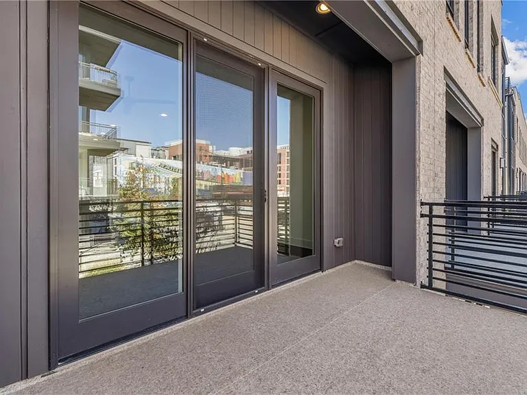 Front Patio (Note: Actual unit has light wooden floors and upgraded fixtures / appliances)