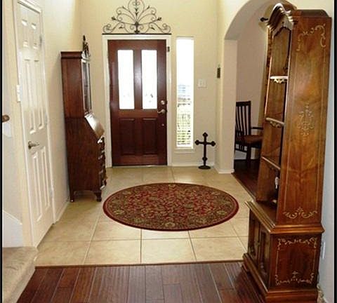Two story entry with tile floors and lead glass front door. Lots of additional storage in closet and under stairs.