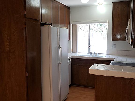 Kitchen with electric range and oven, microwave, dishwasher, garbage disposal and refrigerator/freezer.