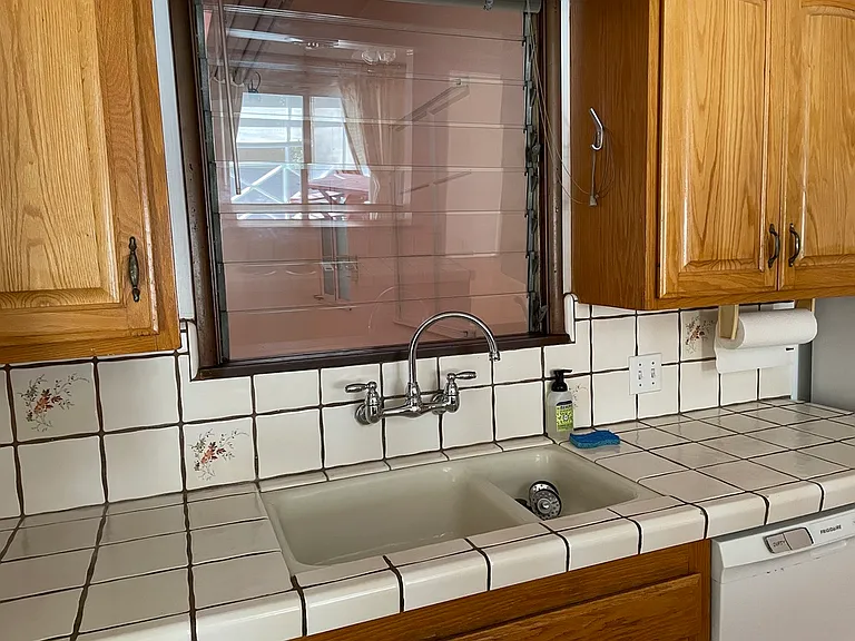 kitchen sink, window into laundry room
