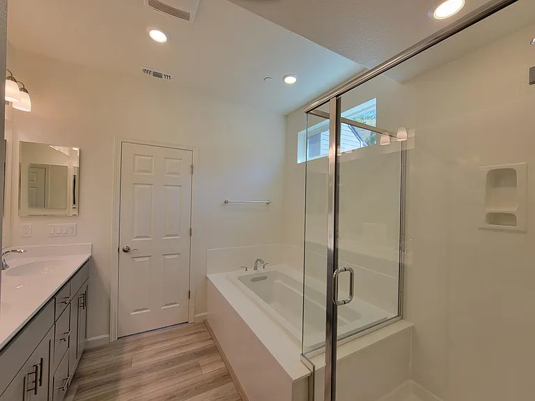 Master Bath with Standing Shower, Soaking tub, dual sink vanity and a view.
