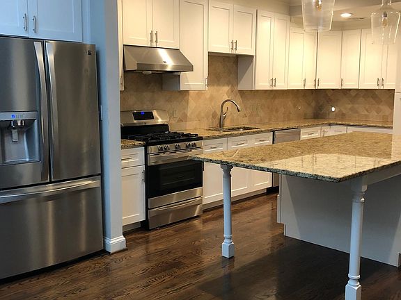 Kitchen with gas stove, refrigerator, microwave and lots of storage cabinets!