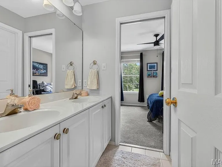 Double vanity with white cabinetry and integrated sinks